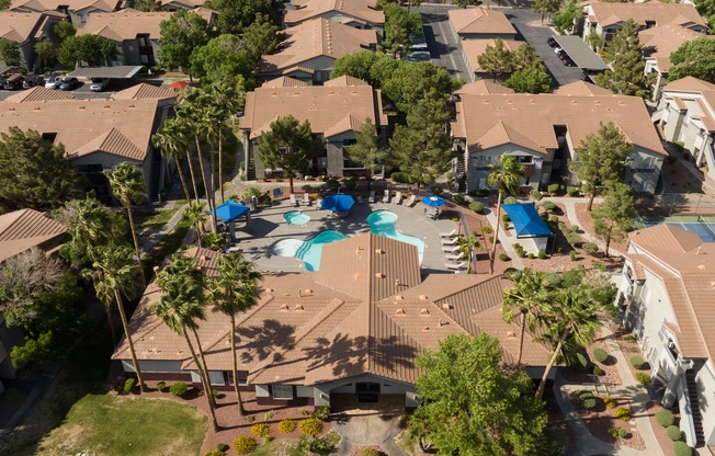 an aerial view of a neighborhood with houses and a swimming pool