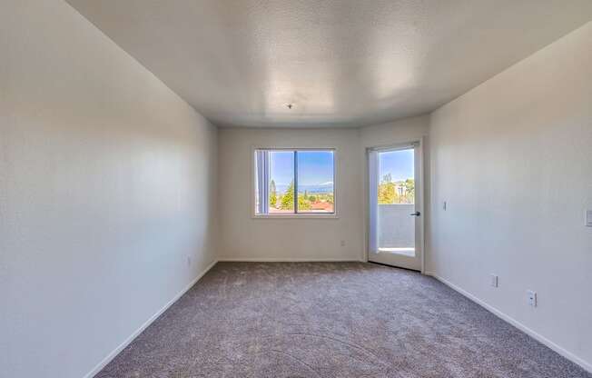 an empty room with a door and a window