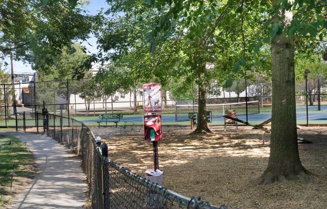 a park with a tennis court in the background and trees in the foreground  at The Lena, Raritan, NJ, 08869