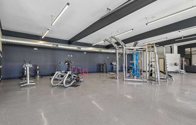 A gym with a grey floor and a white ceiling.