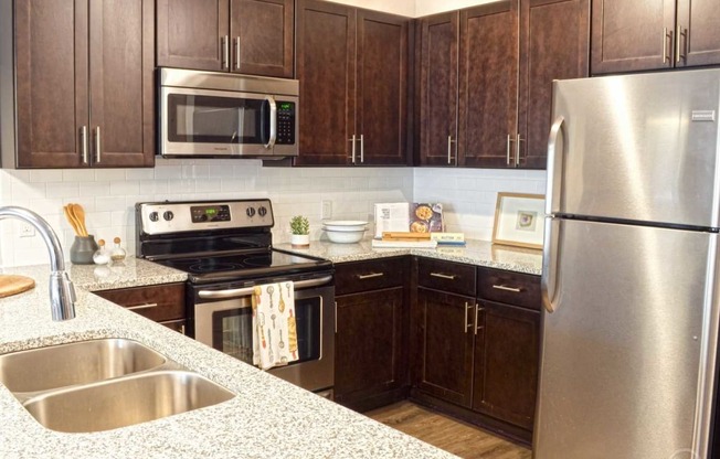 a kitchen with stainless steel appliances and wooden cabinets