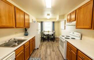 Apartment kitchen and dining room at Woodbridge Apartments located in Randallstown, MD