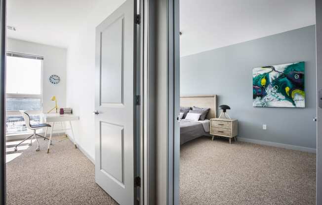 View of two bedrooms with carpeted floors, one bedroom and one office