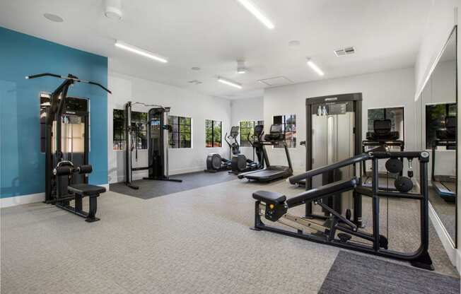 a gym with weights and other equipment in a building