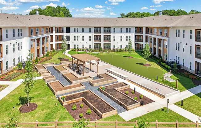Community courtyard with garden, hammocks, bocce, mini golf, grills, and cornhole