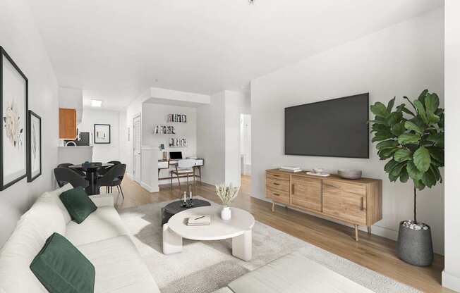 A modern living room with a white sofa, a coffee table, and a TV on the wall.