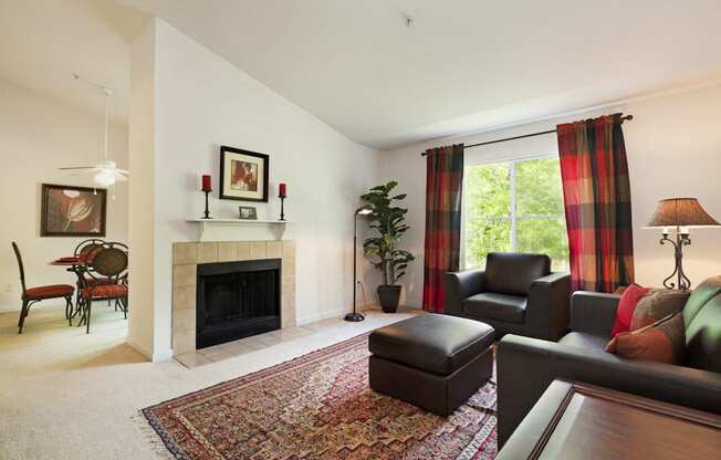 the living room has a fireplace and a large window