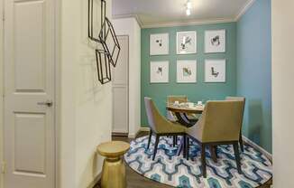 A dining area with a table and chairs.