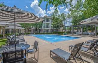 Affordable Houston Texas Apartments – Westchase Forest – Photo of our apartments offer a swimming pool with chairs and umbrellas