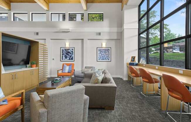 A room with a grey carpet and a wooden ceiling.