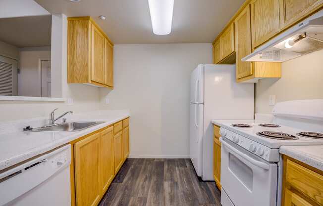 a kitchen with white appliances and wooden cabinets  at Seville at Gale Ranch, San Ramon, California