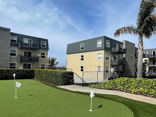 a golf course in front of an apartment building