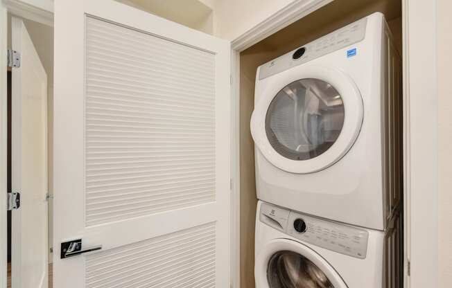Washer and dryer inside a closet with the closet door opened at Morgan Ranch Apartments, Morgan Hill