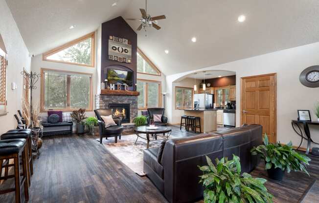 the view of a living room with couches and a fireplace