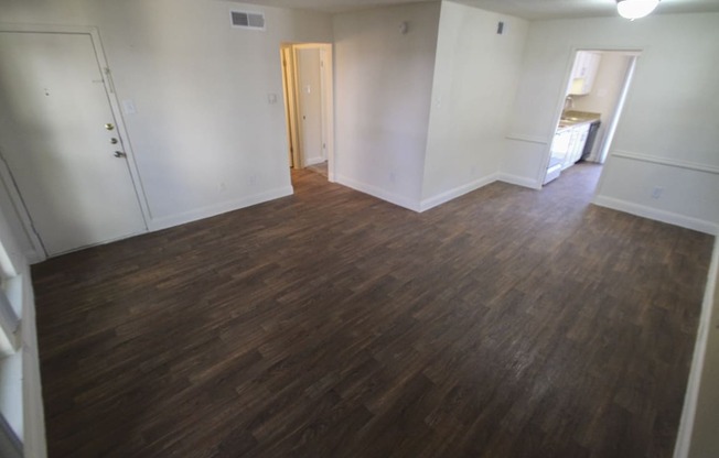 This is a photo of the living room of the 751 square foot 1 bedroom apartment at Woodbridge Apartments in Dallas, TX.
