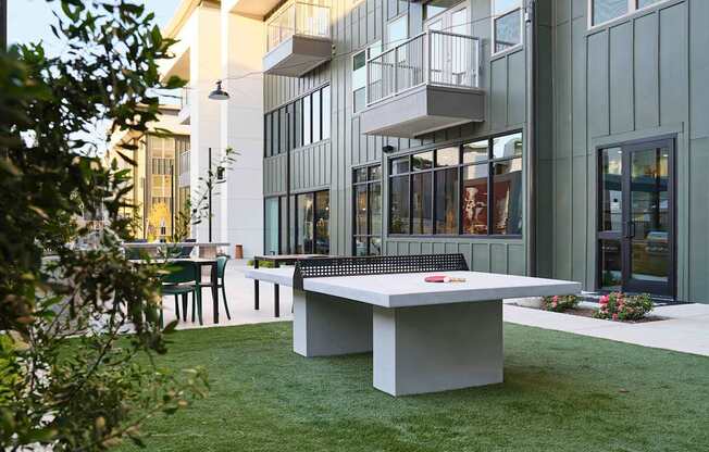 a ping pong table in the backyard of a building