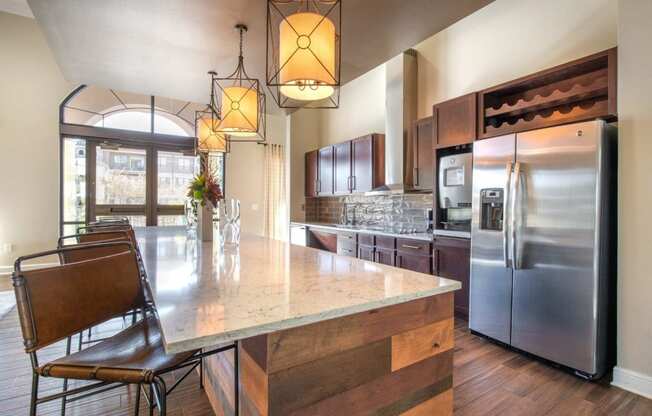 a kitchen with a large island and stainless steel appliances