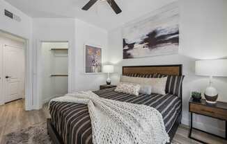 a bedroom with a bed and a ceiling fan