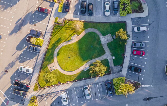 an aerial view of a parking lot with cars and grass  at Linden on the GreeneWay, Florida