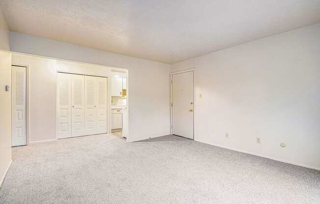 a bedroom with white walls and carpet