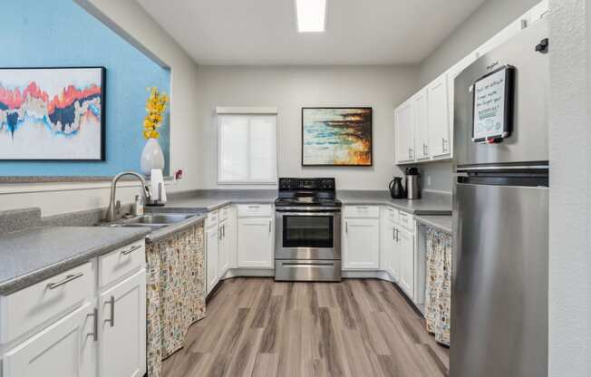 a kitchen with stainless steel appliances and white cabinets