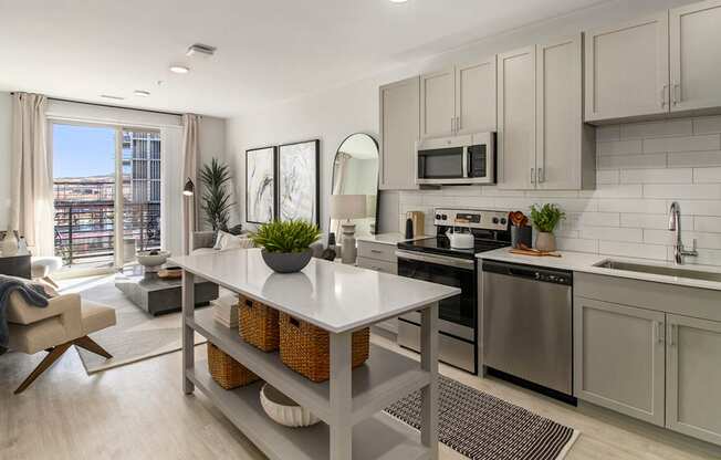 a kitchen with stainless steel appliances and a white table