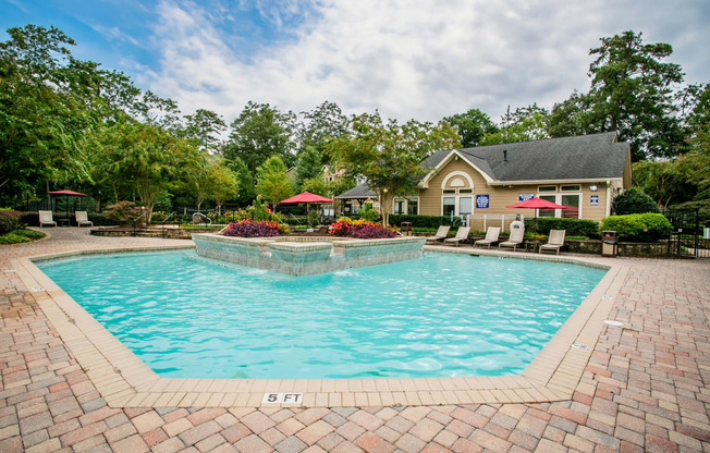 a swimming pool with a house in the background