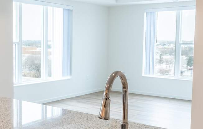 an empty kitchen with a sink and a window