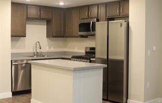 a kitchen with a large island and stainless steel appliances at Loma Villas Apartments, San Bernardino, 92408