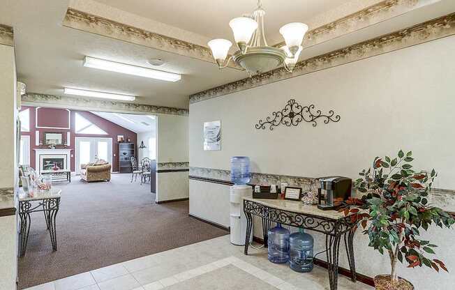 A living room with a couch, chairs, and a table with a plant on it.