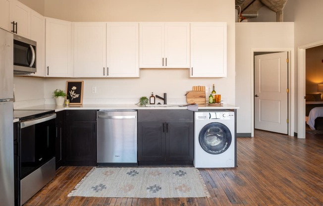 a small laundry room with a washer and dryer at The Draper, St Louis, Missouri