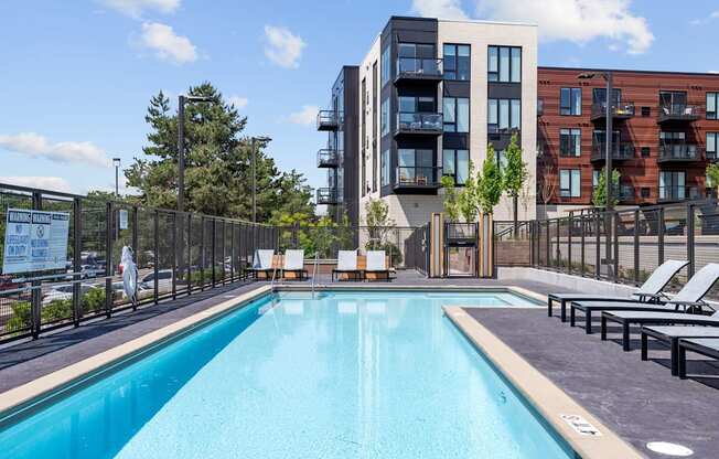 A swimming pool in front of a modern building.