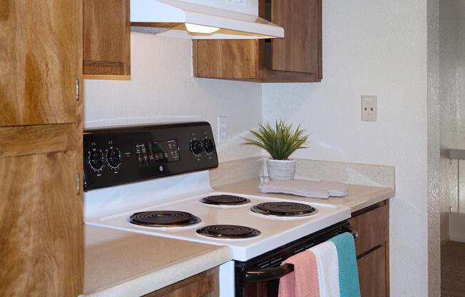 a white stove top oven sitting inside of a kitchen