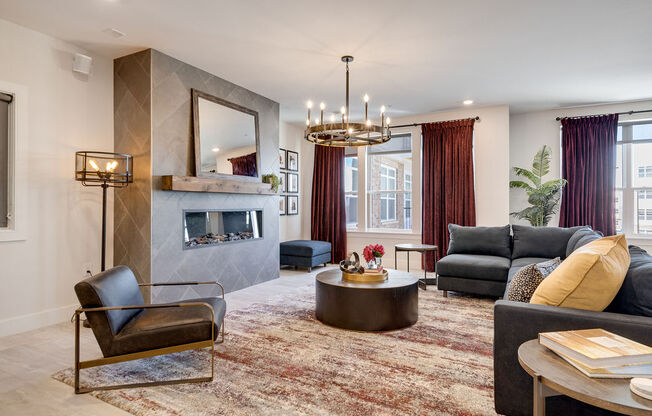 a living room with a fireplace and a chandelier