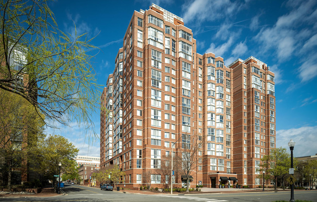 a large apartment building on the corner of a city street