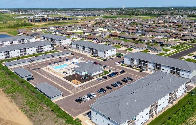 A large white building with a pool in the middle of a parking lot.