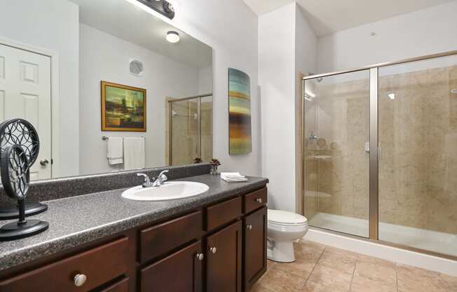 a bathroom with a sink and a shower and a toilet at Sovereign at Overland Park, Overland Park  