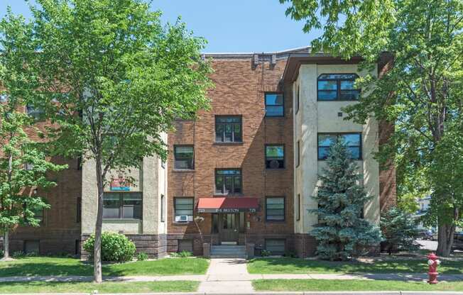 a large brick building with trees in front of it