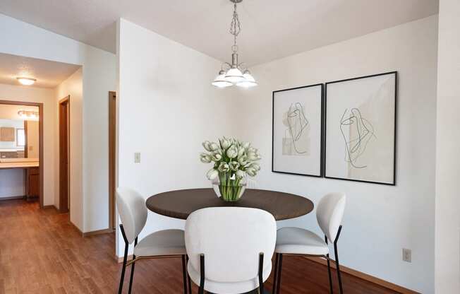 a dining room with a table and chairs. Fargo, ND Rosegate Apartments