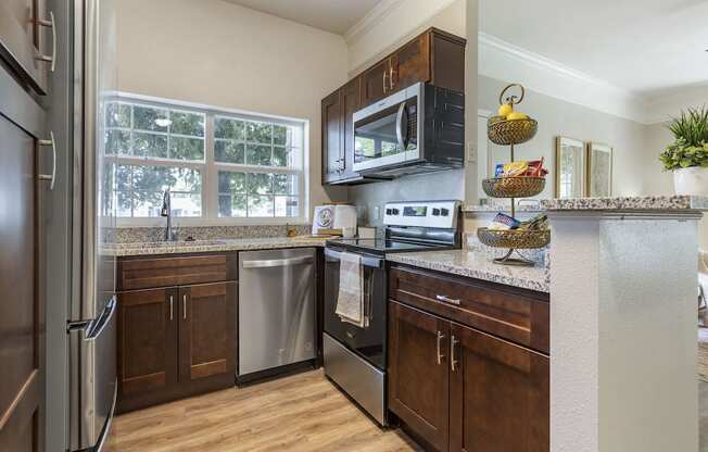 Kitchen with Steel Appliances at Pinehurst Apartments Midvale, UT 84047