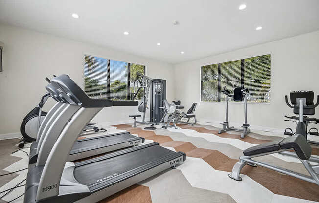 A treadmill in a room with exercise equipment.