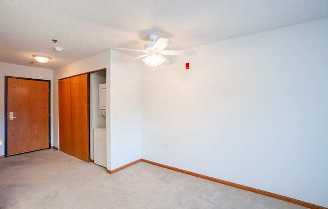 a empty room with a ceiling fan and a closet.  Eagan, MN Glen Pond Apartments