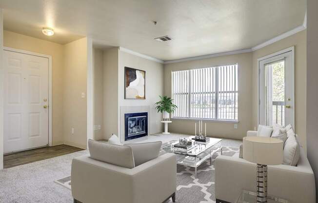 A living room with a white couch, a coffee table, and a painting on the wall.