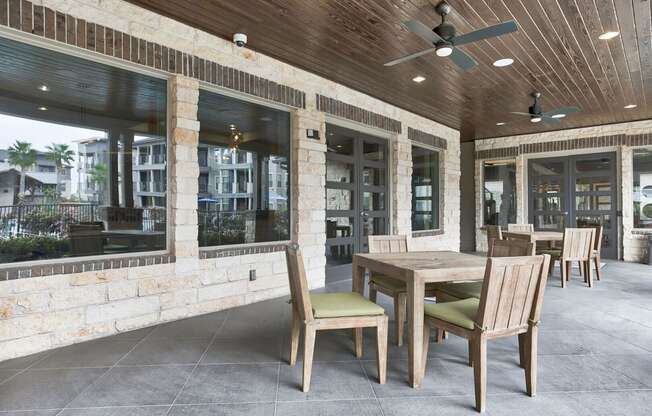 a covered patio with a wooden table and chairs at Legacy Flats, San Antonio