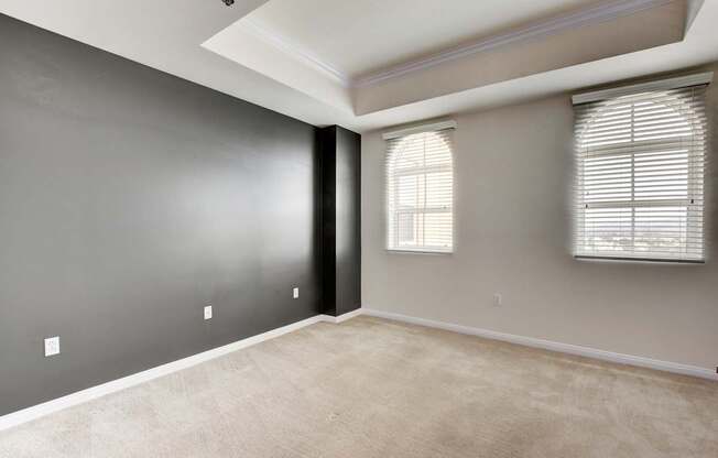 A room with a window and a carpeted floor.