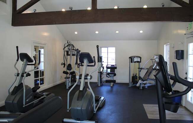 A gym with a variety of exercise equipment.