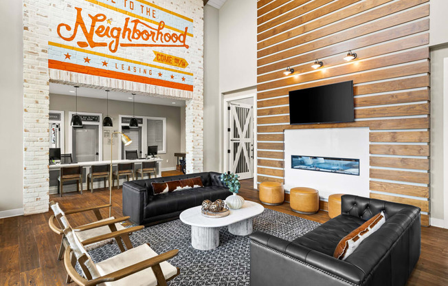 a living room with two leather couches and a white coffee table