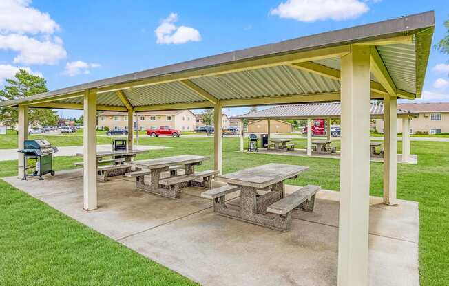 a picnic area with benches and a pavilion