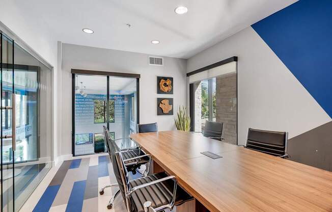 A conference room with a long table and chairs.