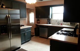 Modern 2 Bed/1 Bath row house with off-street parking!